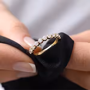 White Gold Double Prong Round Diamond Engagement Ring Being Cleaned with a Cloth