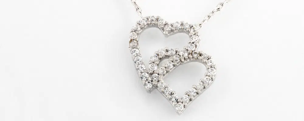 Large heart-cut diamond pendant in a platinum setting, showcasing the classic symbolism of the heart shape in luxury jewelry