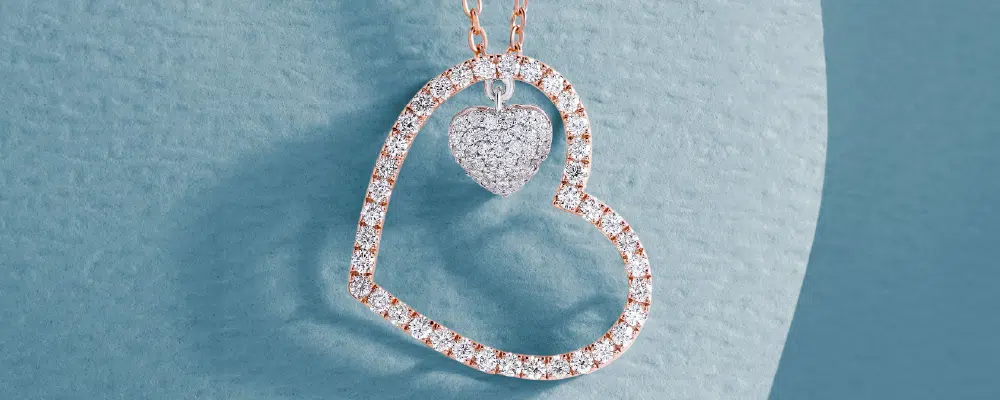 Sterling silver heart-shaped necklace with a brilliant round solitaire diamond at the center, representing a singular deep affection