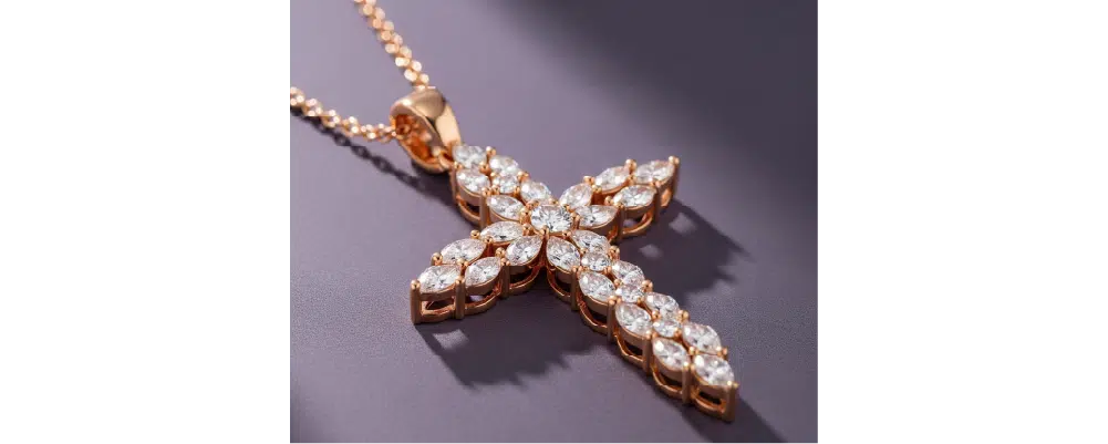 Marquise cut lab-grown diamond cluster cross pendant necklace in 18k rose gold on a grey background.