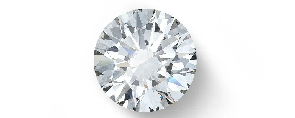 Round brilliant lab-grown diamond showing symmetric facets on a white background.