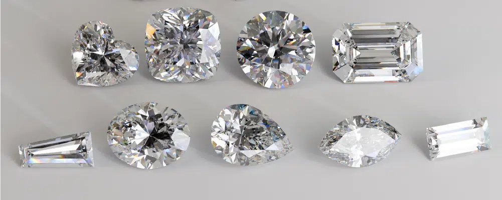 omparison of popular diamond shapes highlighting the unique teardrop profile of a pear cut diamond alongside round, oval, and cushion cuts.