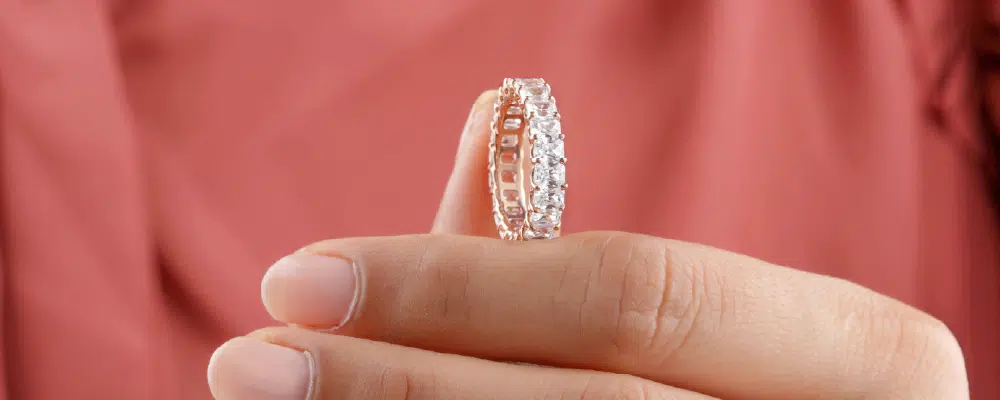 Emerald cut lab-grown diamond eternity band in white gold.