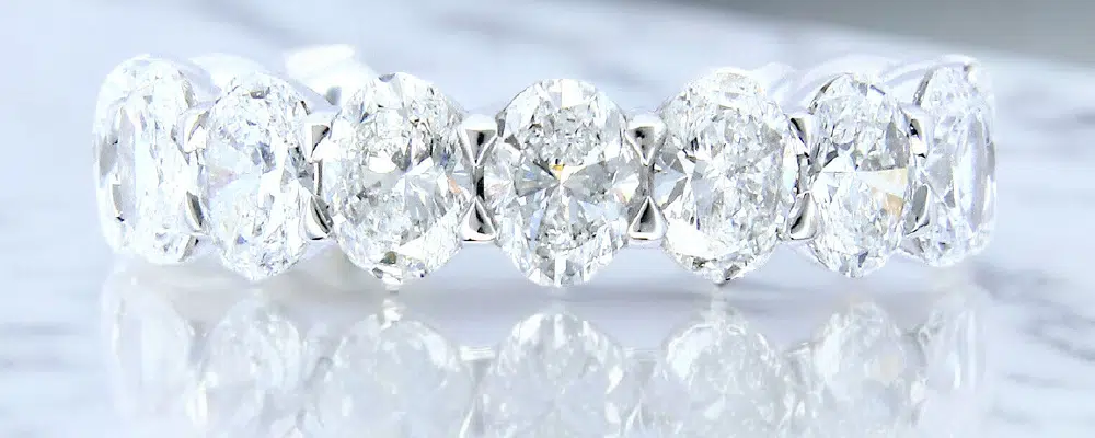 Oval cut lab-grown diamond eternity band in white gold.