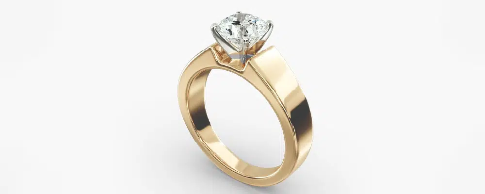 Modern thick yellow gold band engagement ring featuring a princess cut diamond, highlighting the increased metal surface for better durability and ring safety.