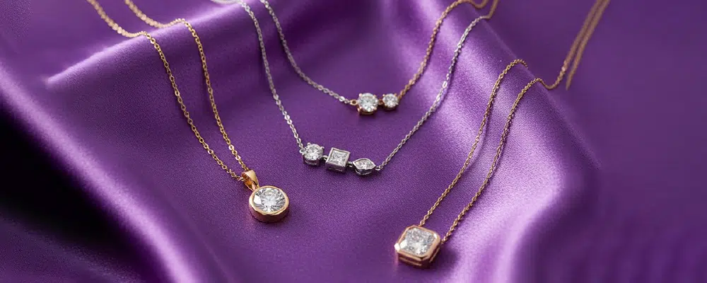 Assorted multi-stone and solitaire lab-grown diamond pendant necklaces in white and yellow gold.
