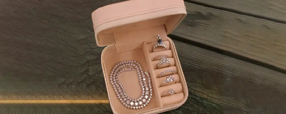 Diamond jewelry collection including a tennis necklace and rings stored safely in a jewelry box after cleaning.