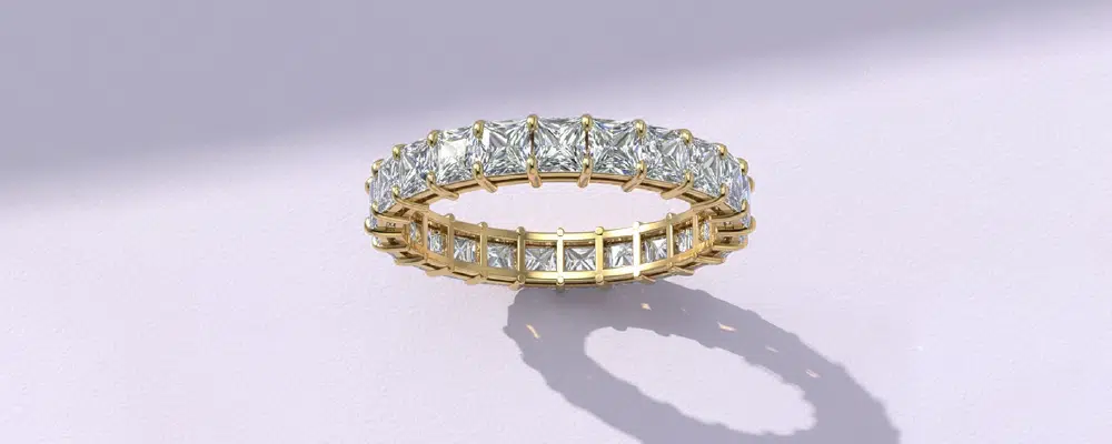 Princess cut lab-grown diamond eternity band in yellow gold.