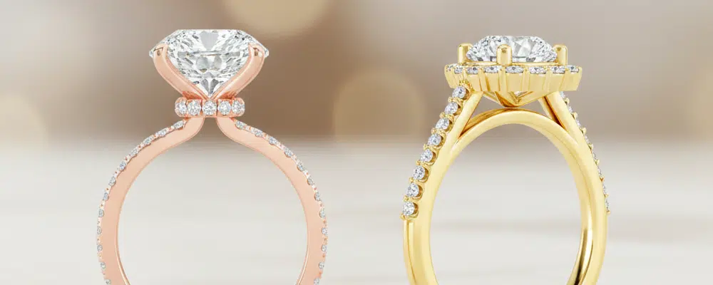 Side profile comparison of a rose gold hidden halo ring next to a yellow gold classic pavé halo setting showing modern design elements