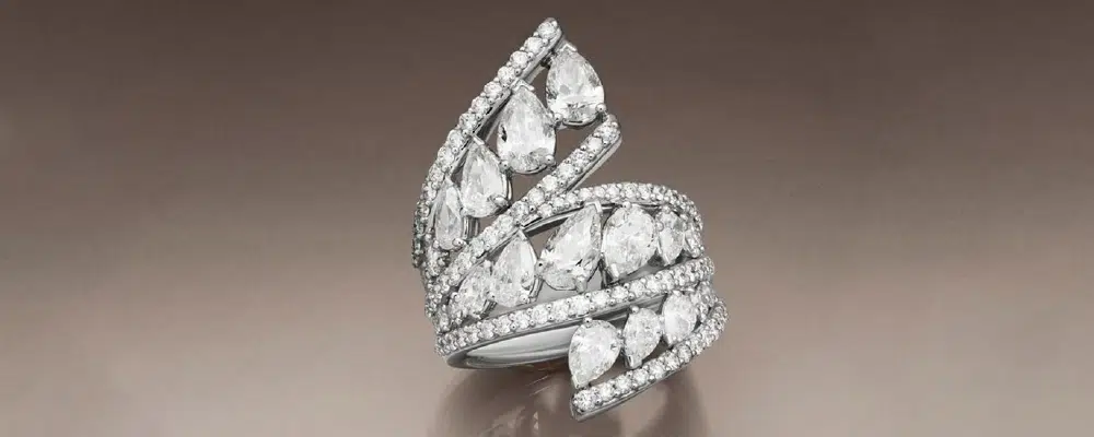 Vintage inspired multi row lab grown diamond statement ring featuring multiple pear shaped diamonds in a wide pave bypass setting.