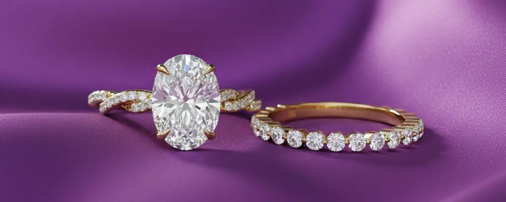 High-end oval diamond engagement ring with twisted pavé band and matching eternity wedding ring for luxury bridal budget planning.