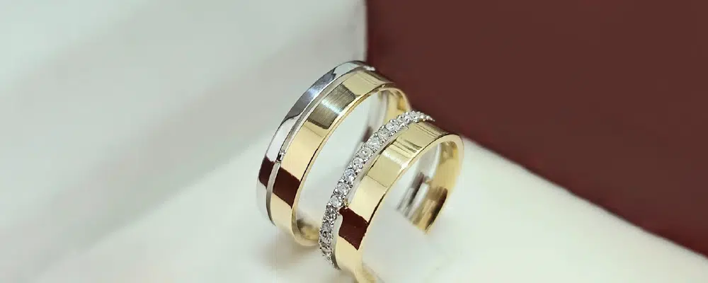 Mixed metal wedding bands in white and yellow gold showing modern two-tone jewelry designs for couples.