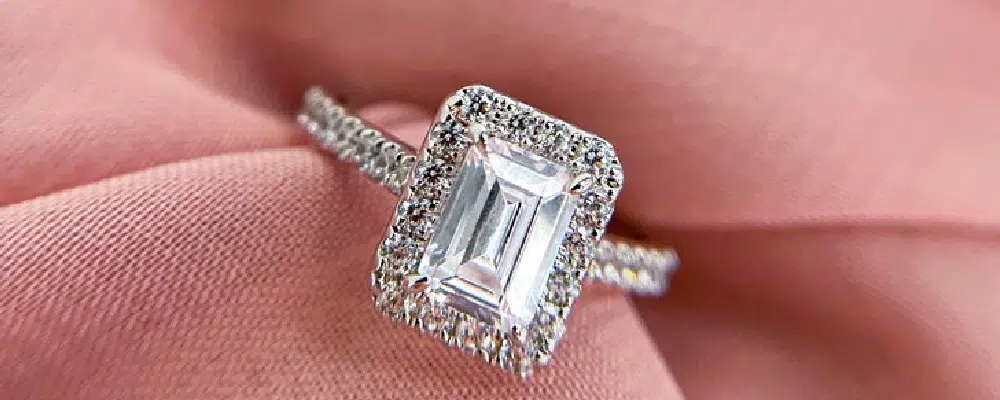 Close-up shot of a vintage style emerald cut halo diamond ring