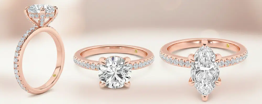 Three rose gold hidden halo engagement rings showcasing a side profile view round cut and marquise cut diamond