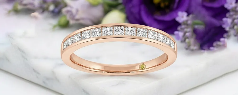 Channel-set Princess cut lab-grown diamond wedding ring in rose gold.
