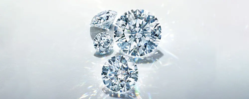 A cluster of brilliant loose colorless diamonds demonstrating high color grade purity.