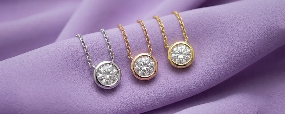 Three round bezel set diamond solitaire pendant necklaces in white rose and yellow gold