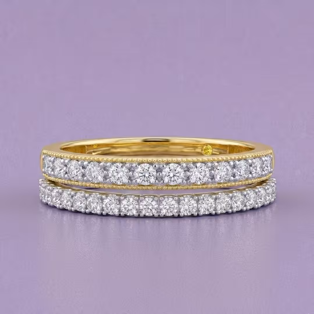 A stack of two delicate lab-grown diamond pavé eternity bands, one in yellow gold and one in white gold, on a purple background.