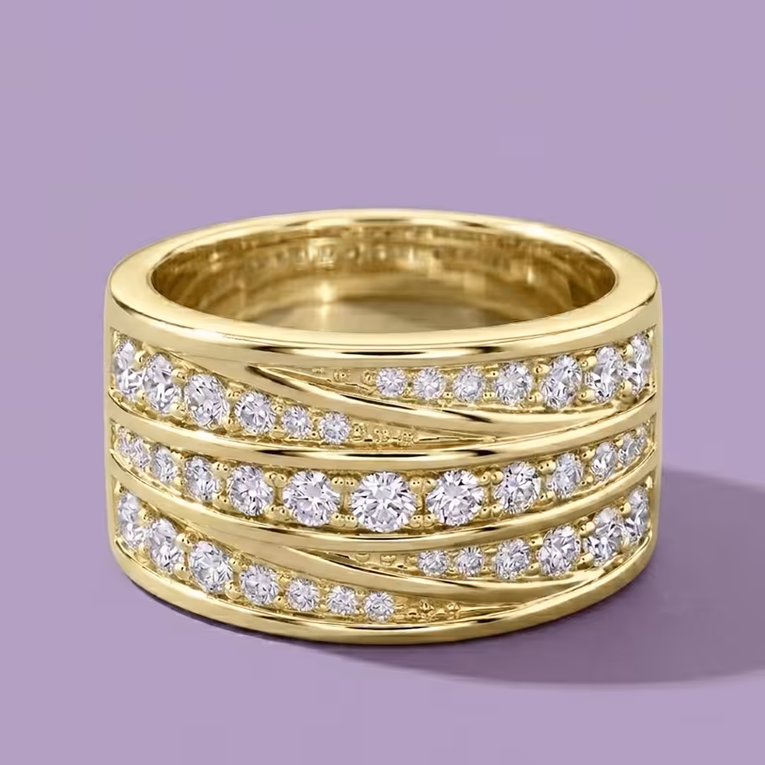 A wide yellow gold cocktail ring featuring diagonal rows of flush-set lab-grown diamonds on a purple background.